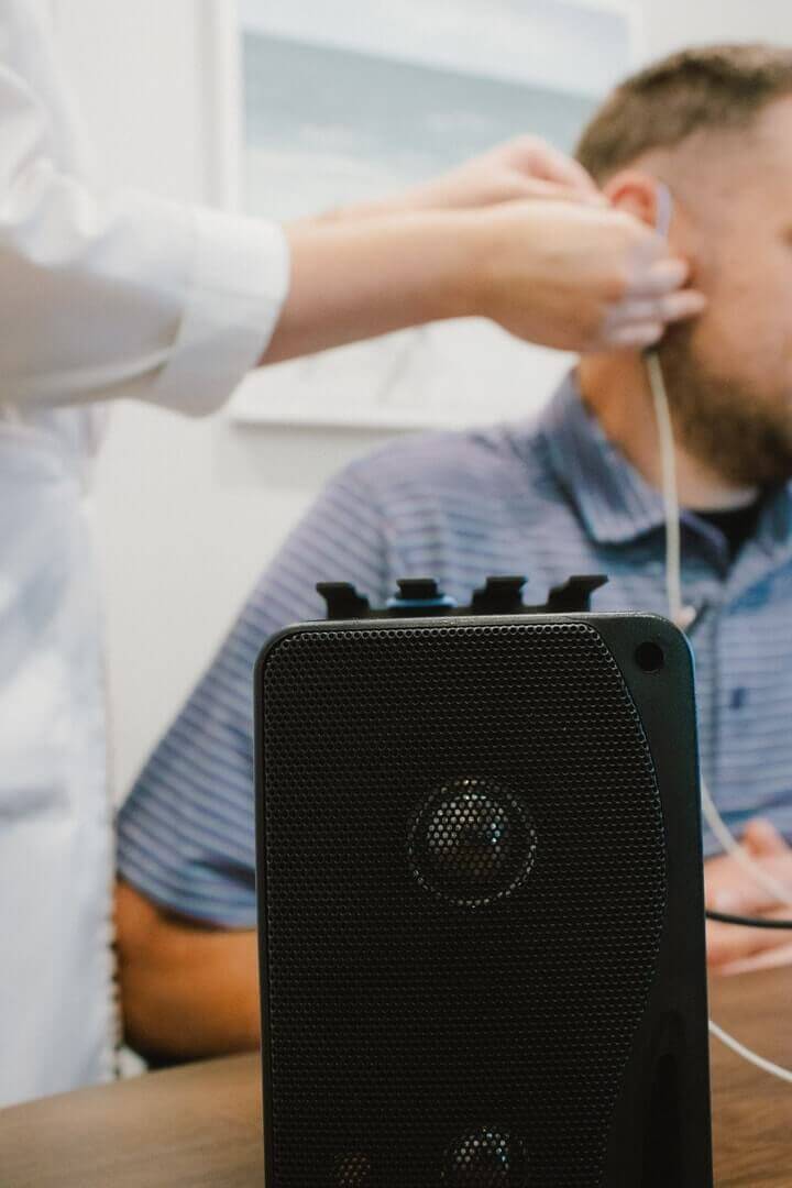 A man getting his hearing aid fitted at North Georgia Audiology